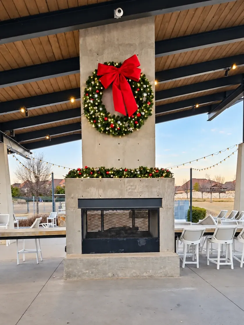 Christmas wreath and garland decorating a community pavilion fireplace